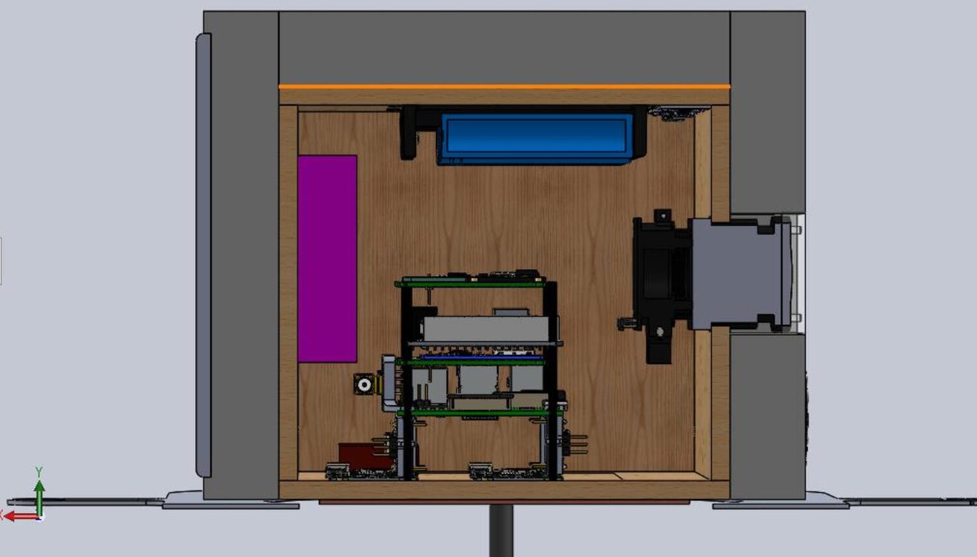 Section view of the payload interior: three stacked circuit boards on standoffs sit inside a plywood-lined box, with a camera mounted through the right-hand wall and further components above.